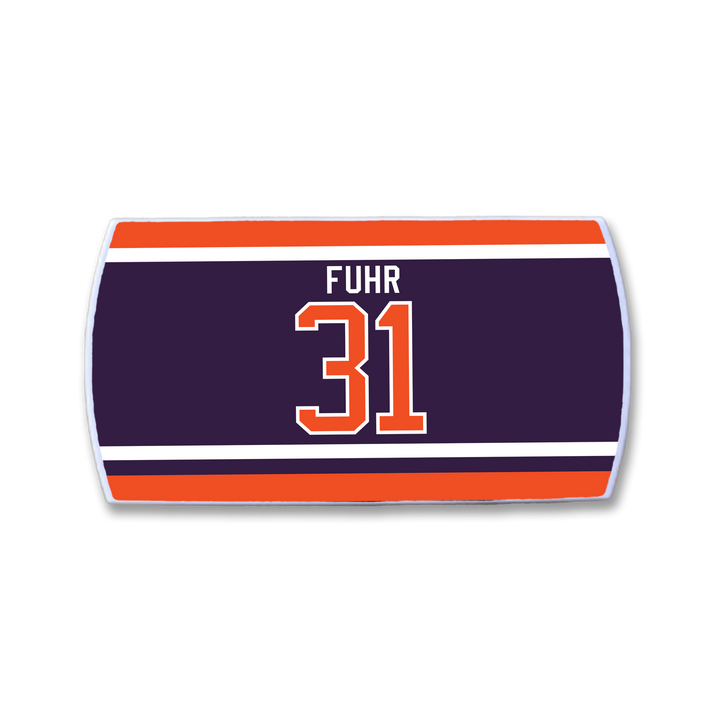 The ZippyBack™ Grant Fuhr hockey jersey nameplate displays "FUHR" and number 31 in bold orange and white on dark blue, bordered by red, orange, and white stripes—a tribute to this legendary goalie.