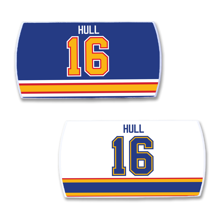 Two ZippyBack™ Brett Hull hockey jersey nameplates: one blue with gold/red HULL 16, one white with blue/gold HULL 16. Both feature red, yellow, and blue stripes at the bottom to honor the legendary goal scorer.