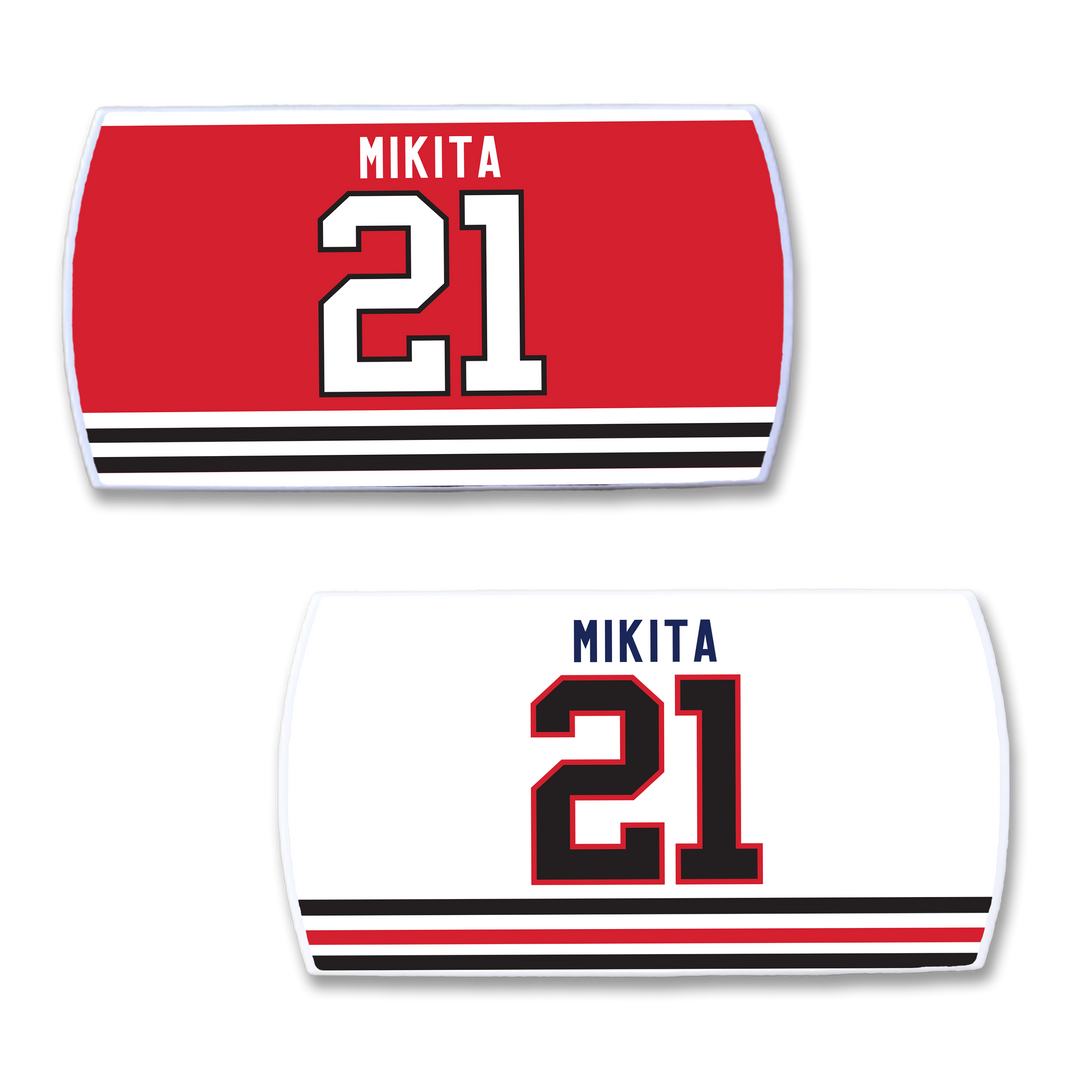 Two ZippyBack™ Stan Mikita hockey jersey nameplates: one red and one white, both with "Stan Mikita" and number 21, plus black and red striped borders—a tribute to a legendary player.